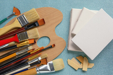 Art tools. Palette, canvases and different paintbrushes. Copy space