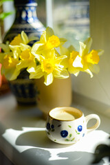 Coffee and daffodils in a beautiful morning moment