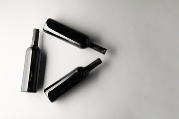 Bottles of wine on white background, flat lay. Space for text