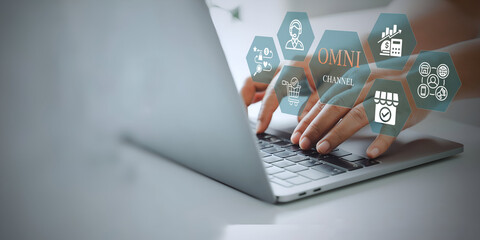 A business person using laptop with Omni Channel Digital Marketing and E-Commerce concept.