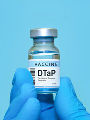 Doctor or nurse hand in medical gloves holds vaccine for DTaP diphtheria, tetanus and Pertussis. Concept of healthcare, immunization, medical protection, and scientific research in medicine