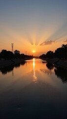 Fototapeta premium Stunning Tigris sunsets in Iraq Baghdad over water, power lines, trees, buildings. Concept of Tigris sunsets in Iraq Baghdad landscape, beauty, tranquility, nature.
