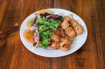 A plate of fried chicken and salad