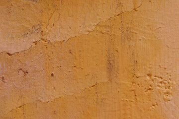 Fototapeta premium Abstract background made of orange plaster.