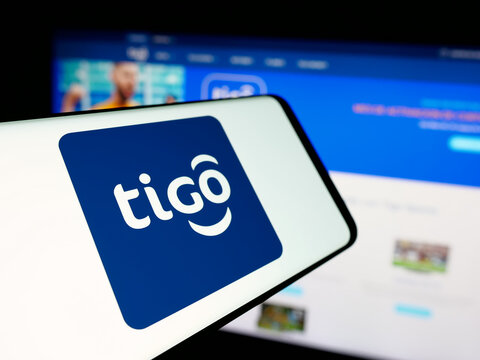 Stuttgart, Germany - 04-09-2025: Smartphone with logo of telecommunications company Tigo Bolivia on screen in front of website. Focus on center-left of phone display.