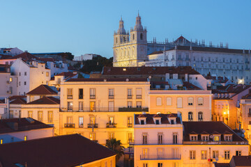 A cityscape view of Lisbon’s historic district from Miradouro de Santa Luzia, of the Church of...
