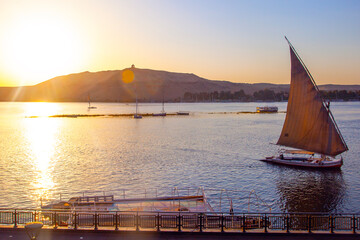 Sailing boat on the Nile river at sunset time, Aswan, Egypt