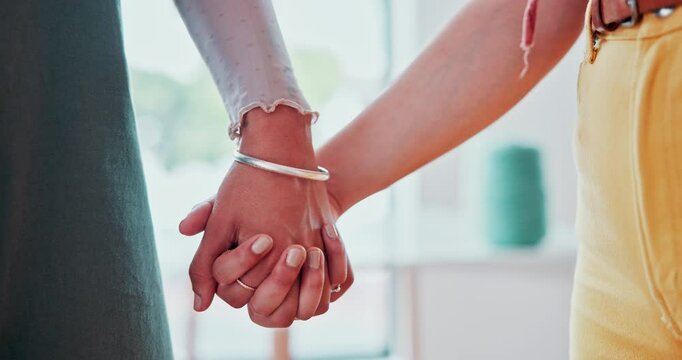 Couple, holding hands and together for care indoor, lesbian and bonding with touch in healthy relationship. People, trust or solidarity in union in commitment, support or symbol of love with kindness