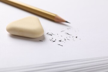 Eraser, pencil and scraps on paper, closeup