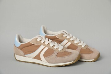Pair of stylish sneakers on light grey background. Casual shoes