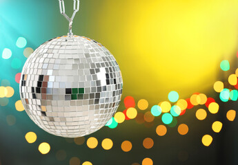 Shiny disco ball on color gradient background with blurred lights. Space for text