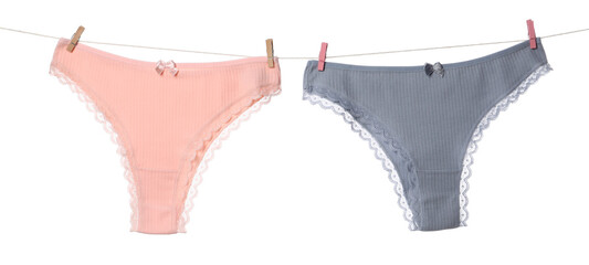Beautiful panties on clothes line against white background