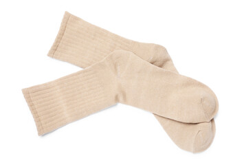 Pair of beige socks isolated on white, top view