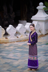Fototapeta premium Pretty Asian women in traditional Thai dress. Beautiful conventional Thai dresses Lanna style. Fashion Thai dresses are popular with travellers in Chiang Mai, Thailand.