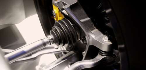 Car suspensions. Close up of a car suspension parts system such as CV joint Rubber boot and Control arms bushing Steering rack axles Shock absorber suspension Brake. Repair and spare parts for cars.