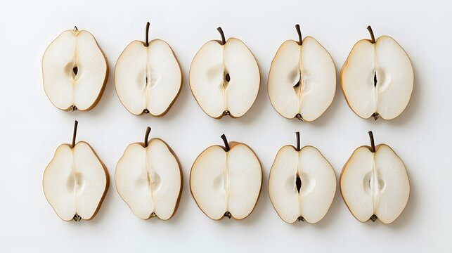Fototapeta Ten halved pears arranged in a neat grid pattern on a white background.  The pears are light brown with a creamy white interior, creating a visually appealing, minimalist food image.