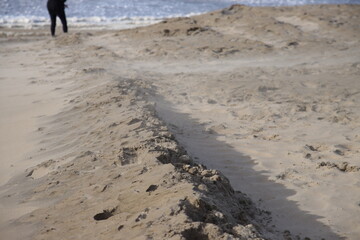 Beach with sand and poles at the Noordwijk promonade
