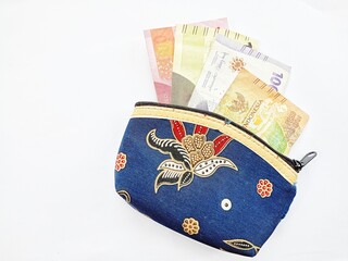 small batik pattern wallet containing rupiah money