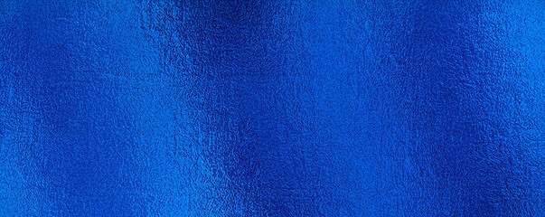 Matte blue metallic foil texture with a grainy sanded effect, ideal for modern backgrounds, wallpapers, and sleek design projects.

