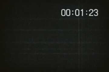 Flickering Black Timer Screen With White VHS Timecode Overlay