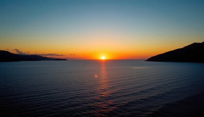 Fototapeta premium Sunset scenic view over calm ocean waters coastal landscape nature photography serene environment aerial perspective