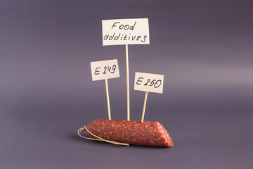 The concept of food additives used in various sausage products. Sausage and signs with inscriptions...