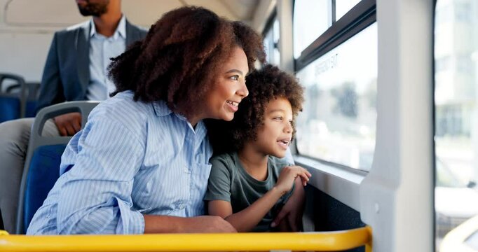 Happy, mother and child travel on bus with window, city commute and sightseeing adventure. Bonding, woman and curious son on public transport for family trip, discussion or journey on weekend break