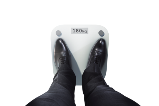 Person in formal shoes stands on scale showing 180kg, top view, isolated on white background. Concept of weight, health, business lifestyle