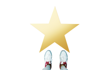 Feet of a person in sneakers standing before a gold star on white background, isolated closeup layout for concept of achievement or recognition