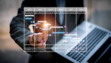 Scheduling activities with a planning software, Corporate strategy for finance, operations, sales, marketing. Project manager working with Gantt chart schedule to plan tasks and deliverables.