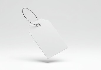 A simple white tag with a metal ring on a white background for product labeling and pricing needs