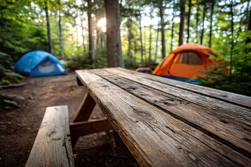 Fotobehang Relaxing camping by wooden table in forest with two tents, at sunset background © Imagine Stuff