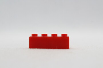 Naklejka premium Red lego brick isolated on a white background 