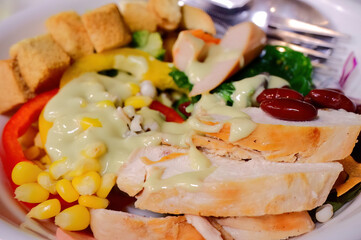Chicken salad with corn, croutons, and red beans, healthy eating