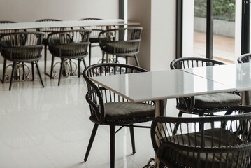 Restaurant interior with tables and chairs, modern design.
