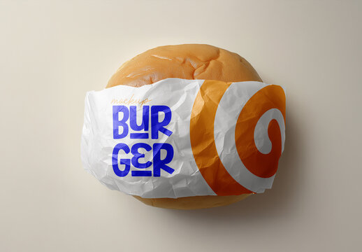 Wrapped Burger Mockup &ndash; Realistic Top View Fast Food Presentation with Bold Printed Paper and Crumpled Texture for Takeaway Branding and Menu Design