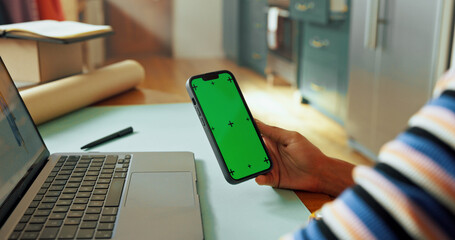 Hand, phone and green screen for small business, mockup and fashion boutique startup with online sales. Designer, woman and website space for internet store, retail ecommerce or quality control