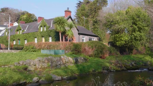 Picturesque scene of ivy covered cottage along the riverside. Rostrevor, Down, Northern Ireland