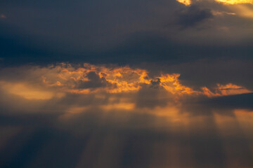 The sunlight shines through the clouds, it's so beautiful. in the morning