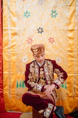 Obraz premium Traditional Minangkabau groom dressed in a luxurious wedding costume