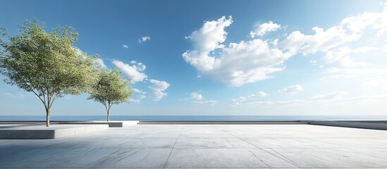 Obraz premium A stone-paved pathway flanked by gray planters with trees, leading toward a calm sea under a blue sky with white clouds, wide-angle composition emphasizing horizon symmetry and natural serenity.
