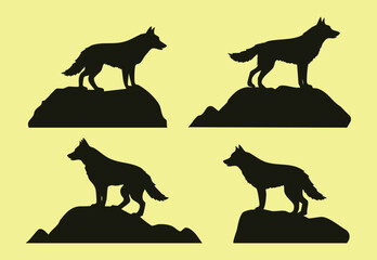 Set of four isolated silhouettes of wolves standing on rocks vector design