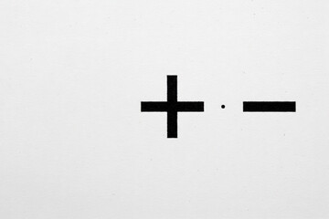 Plus and minus symbols on a white background, a visual metaphor for balance. Space for text.