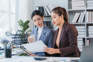 Businesswomen Reviewing Documents in Office