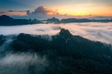 Golden sunrise over foggy mountain in countryside at tribe village of Ban Jabo