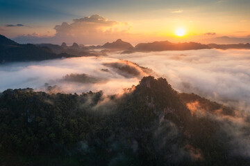Golden sunrise over foggy mountain in countryside at tribe village of Ban Jabo