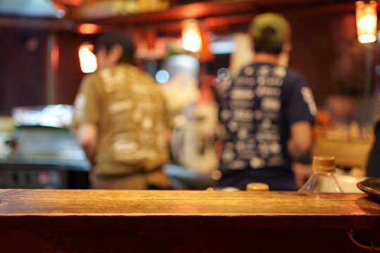Wooden tabletop of traditional Izakaya restaurant blurred scene