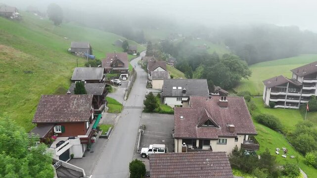 7 juli 2025, Wildhaus-Alt Sint Johann, Switzerland. Drone flight above the village centre of Wildhaus, a charming village near the Alpstein mountain range. Small alpine town centre, houses.