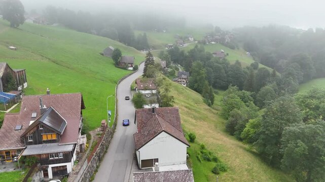 7 juli 2025, Wildhaus-Alt Sint Johann, Switzerland. Drone flight above the village centre of Wildhaus, a charming village near the Alpstein mountain range. Small alpine town centre, houses.