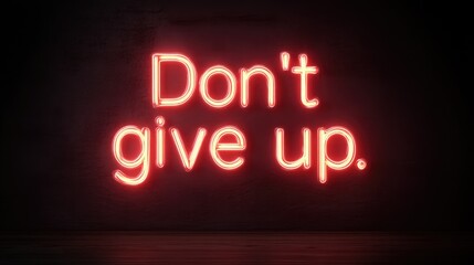 Neon lettering in red glowing light with a dark background, showcasing the inspirational phrase 'Don't give up'. Symbolizing persistence and determination, perfect for motivational themes.
